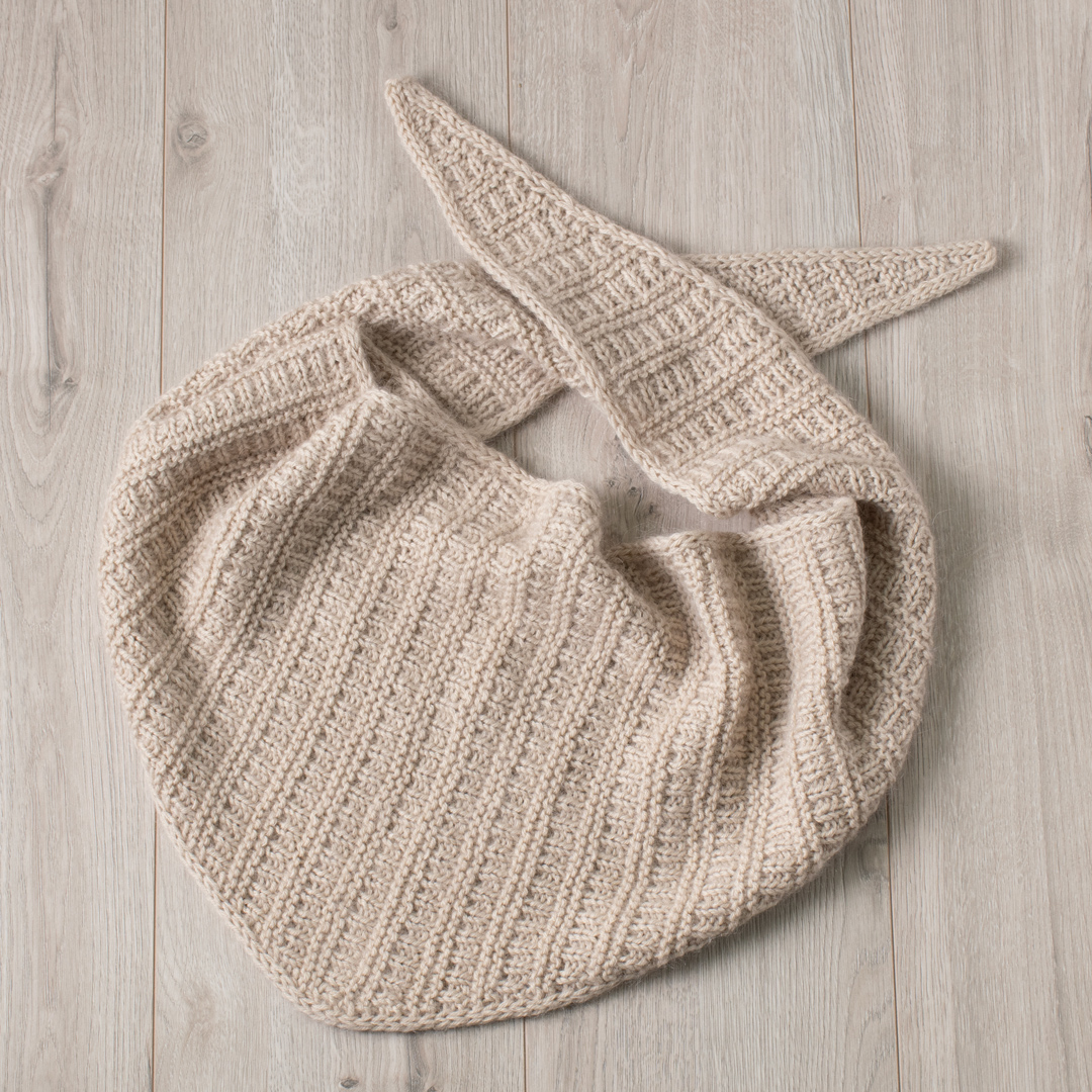 Knitted triangular scarf.