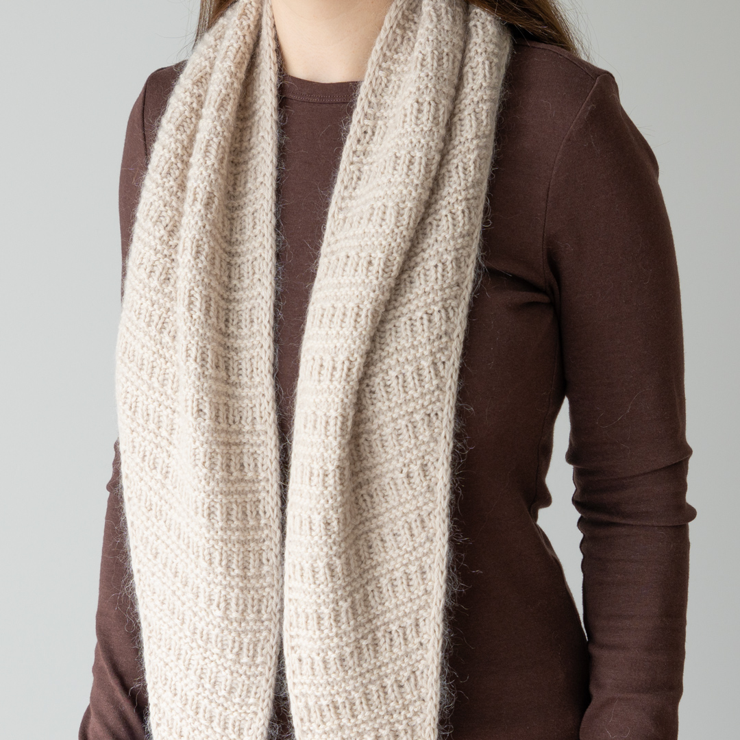 Knitted triangular scarf.