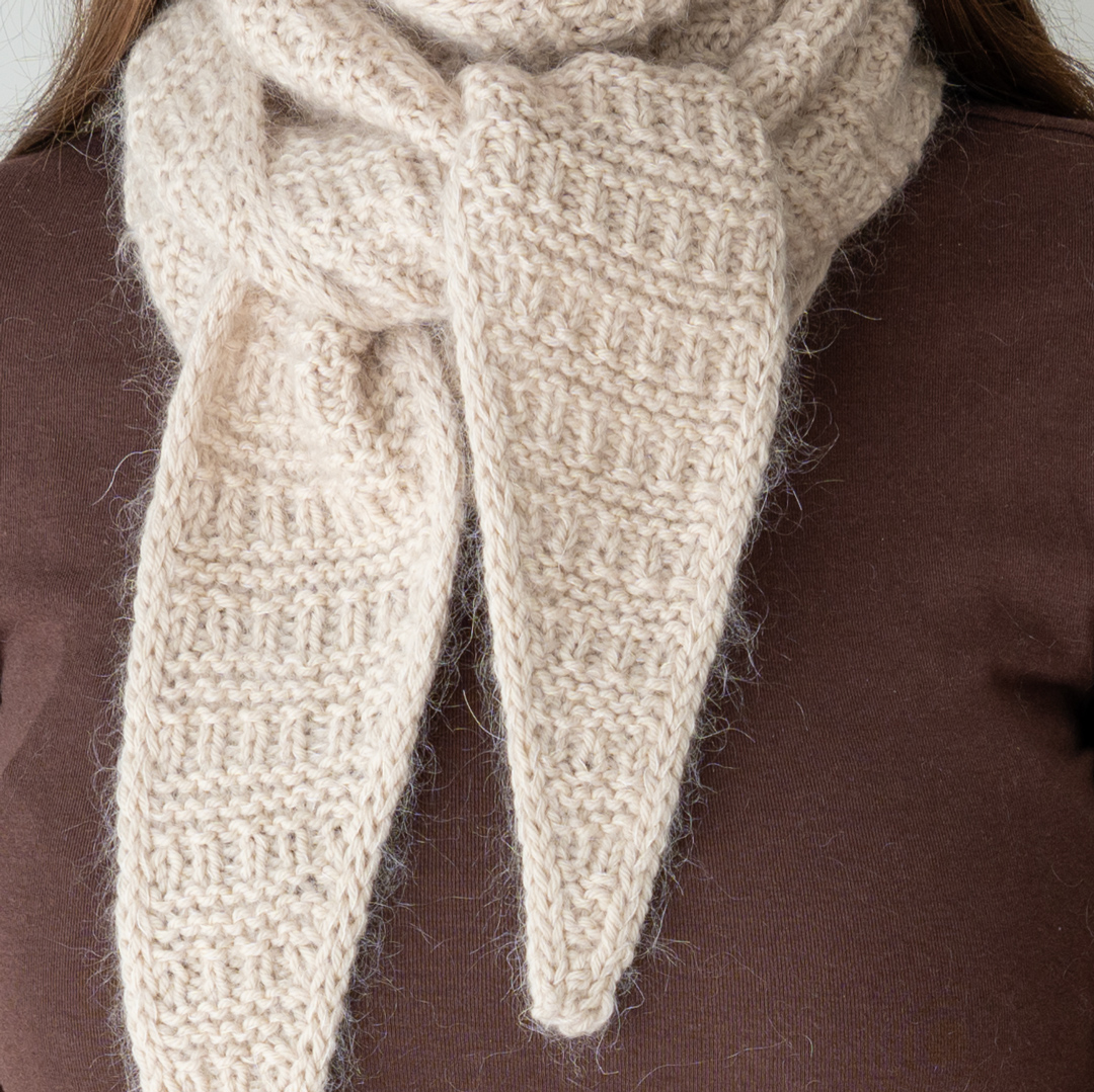 Knitted triangular scarf.
