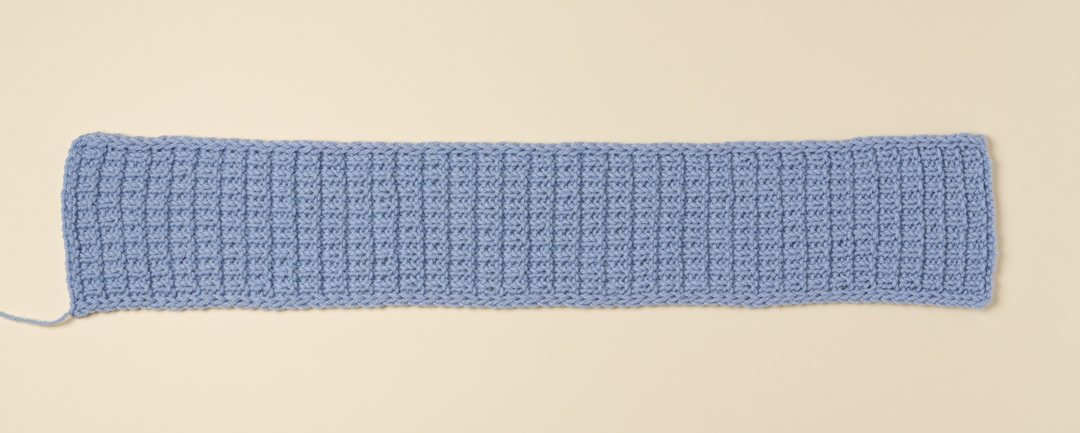 Seaming a knitted headband.