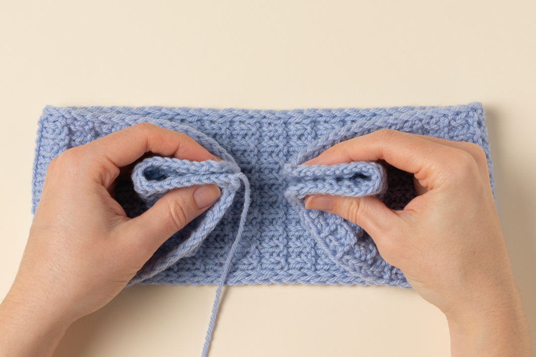 Seaming a knitted headband.