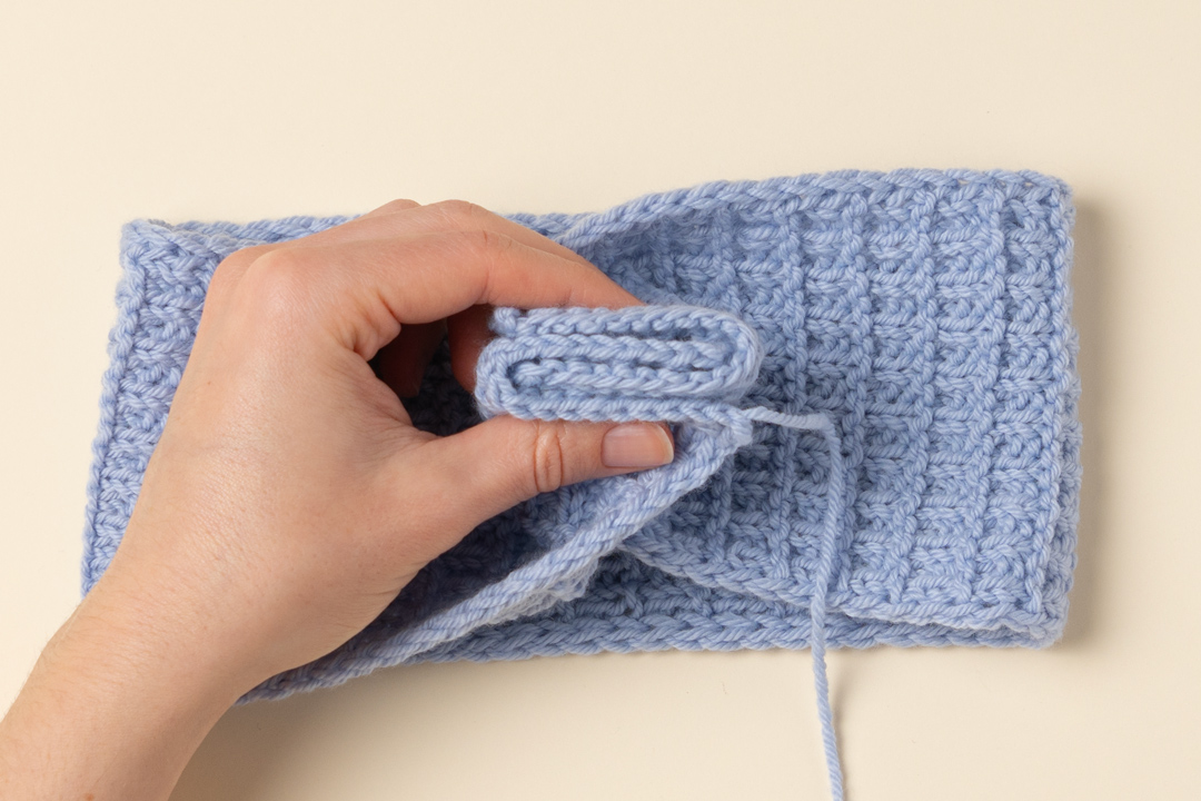 Seaming a knitted headband.