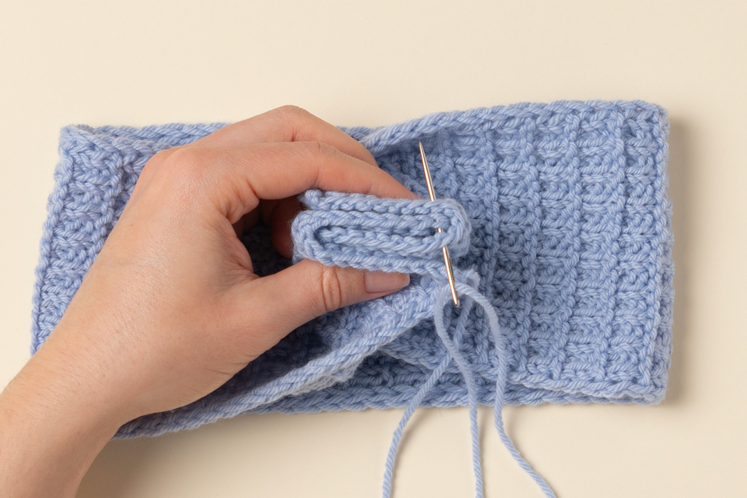 Seaming a knitted headband.