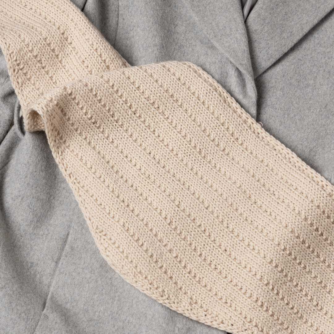 Knitted triangle scarf.